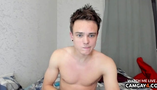 Handsome young guy with blue eyes stroking his dick in webcam