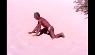 Tanned guy on beach in tiny string thong (temporarily!)