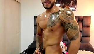 Muscular guy stroking his cock