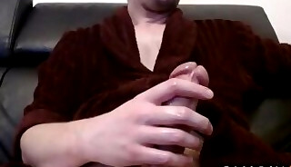 Guy in dressing gown masturbates on his couch