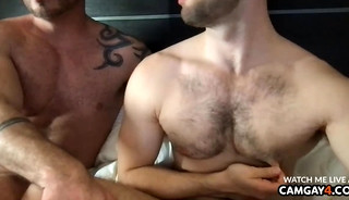 Two handsome men kissing and touching each other's cocks
