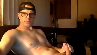 Man with glasses masturbating in webcam