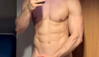 Muscular singlet boy jerks off and plays with his ass
