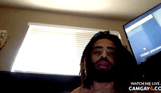 A sexy black guy with a big cock stroking it and his anus touching himself