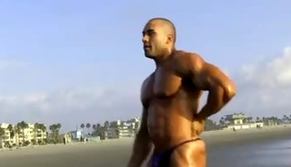 muscle stud poses on the beach