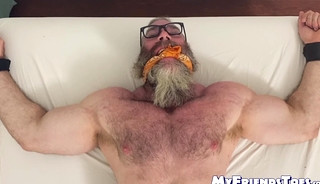 Bound bearded muscular hunk recives body and foot tickling