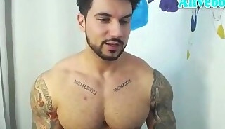 muscle bodybuilder with tattoos shows off his sexy body