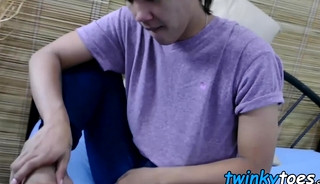Young oriental Asian worships his feet while masturbating