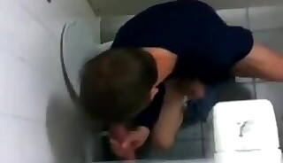 Teenager sucks and jerks dick through GloryHole