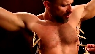BDSM session for submissive muscular dude with pincers