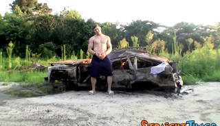 Muscular jock Elijah Knight wanks off his fat cock outdoors