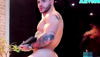 Athletic and handsome guy with tattoos shows off hot body