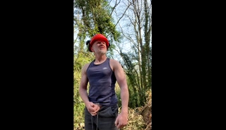 Beefy muscular lumberjack Daddy flexes muscles, lifts tree stumps and jerks off near workmates in