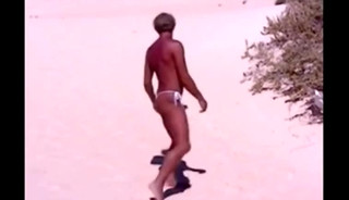 Tanned guy on beach in tiny string thong (temporarily!)