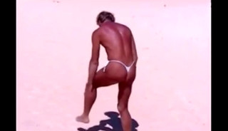 Tanned guy on beach in tiny string thong (temporarily!)
