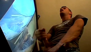 Thug pleases himself with his hands next to recording TV