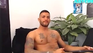 Sexy fit bearded hunk with tattoos strokes his cock